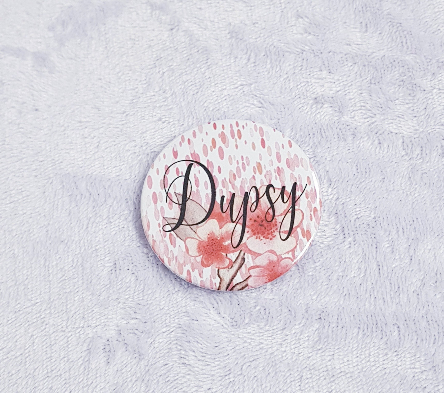 Floral pocket mirror showing front coral design and back mirror surface