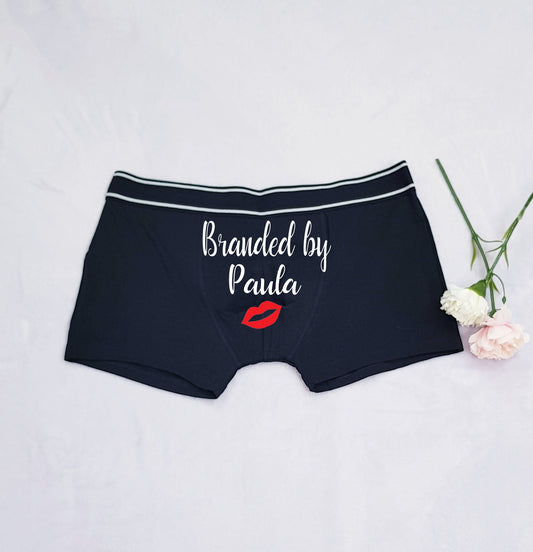 Close-up of personalised groom boxers showing custom name and kiss mark detail on cotton fabric