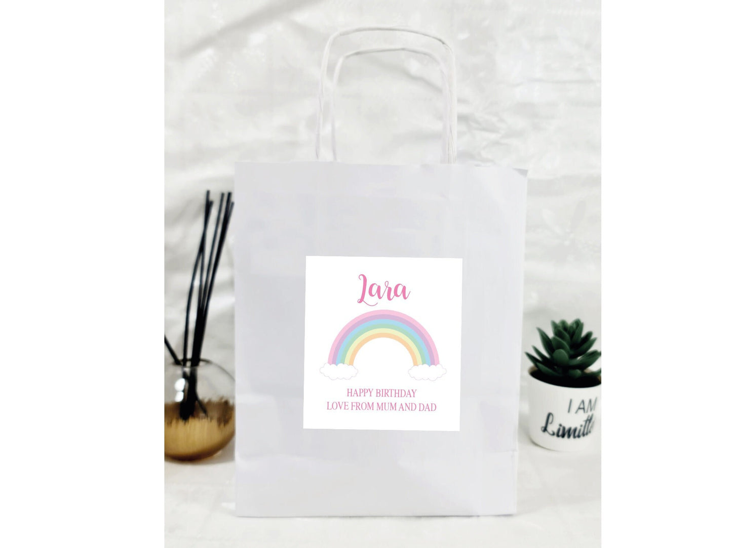 Personalised rainbow paper gift bag with custom name and message sticker for celebrations