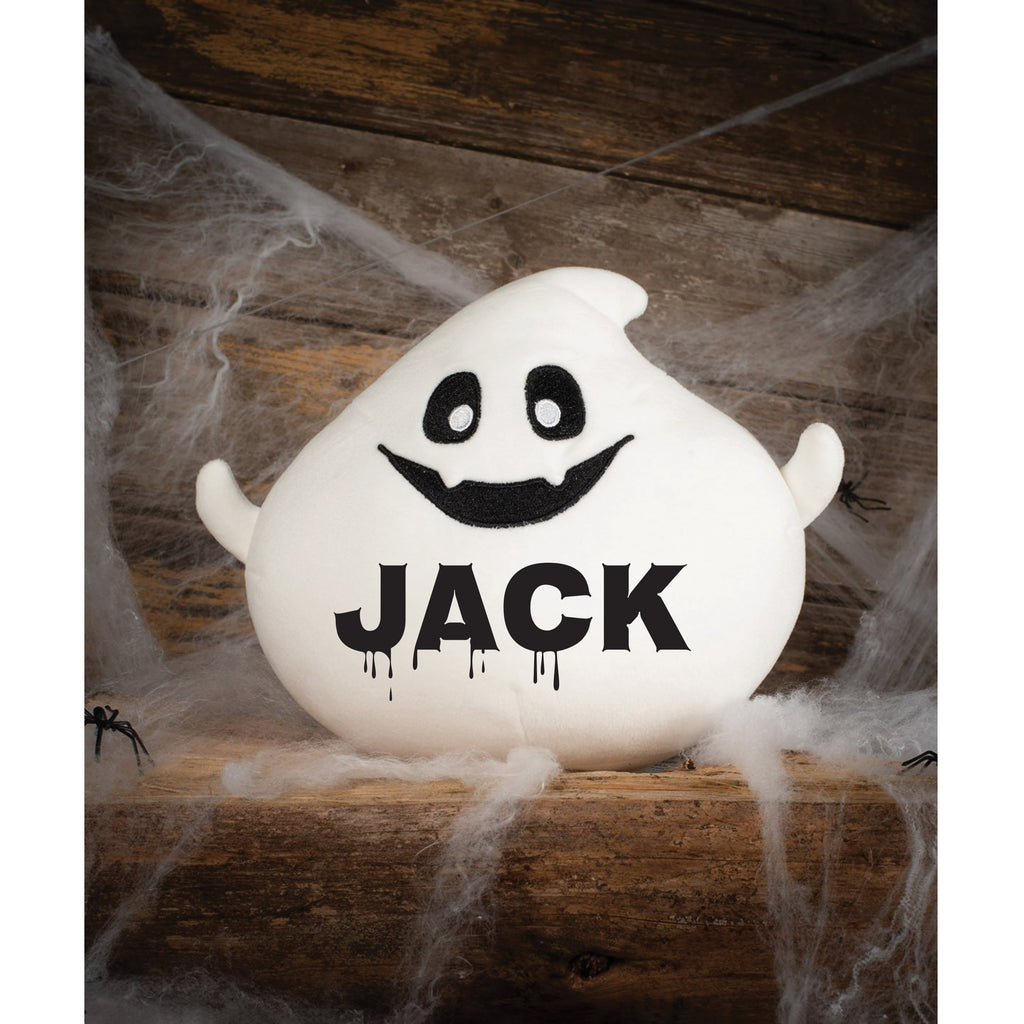 Ghost-shaped light with 'Jname' text on a wooden surface with spider webs