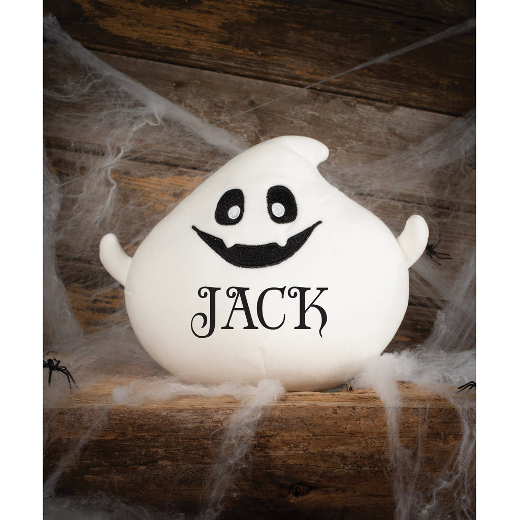 Ghost-shaped decoration with 'name' text on a wooden surface with spider webs