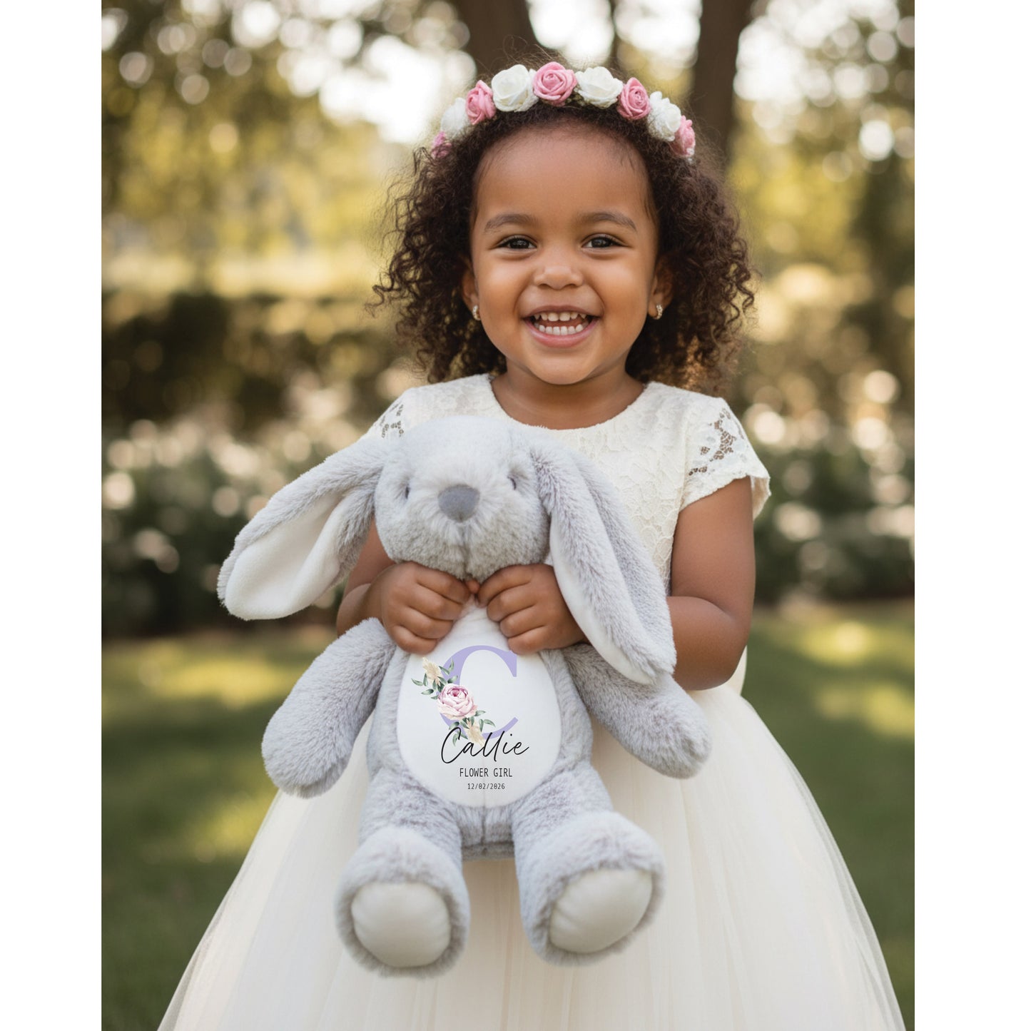 Child holding a gray stuffed bunny with a floral crown outdoors