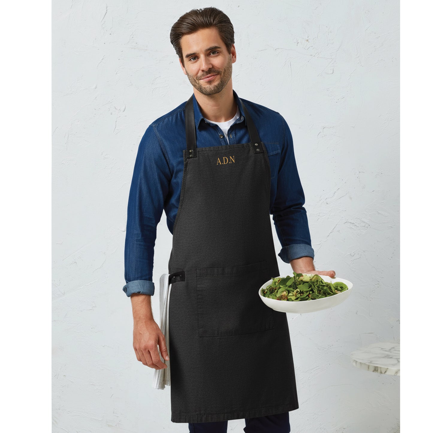 Embroidered apron showing tablet pocket and pen slot detail