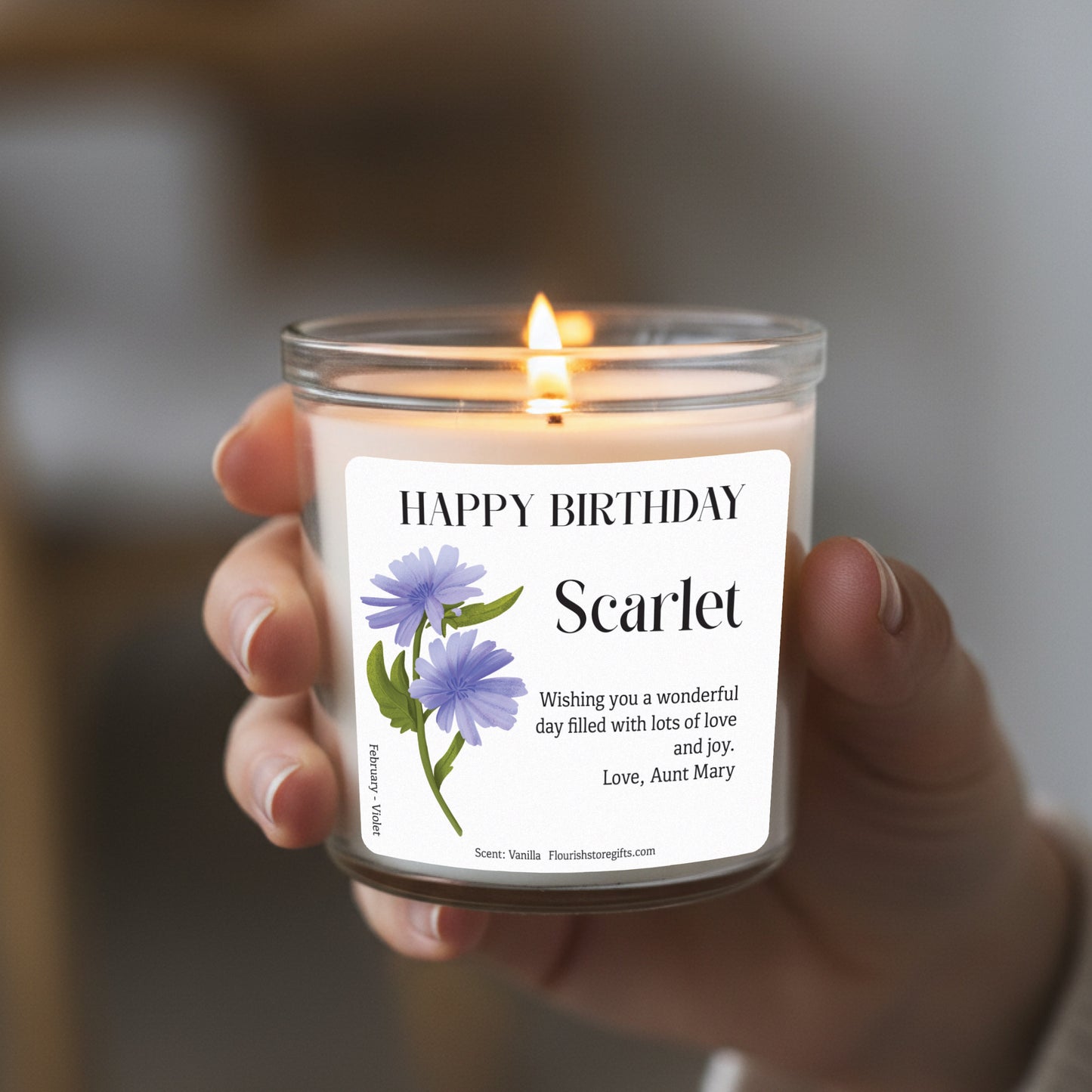 Birth flower candle showing glass container and label design