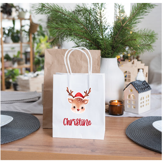 Personalised reindeer Christmas gift bag with custom name on twisted handle paper bag