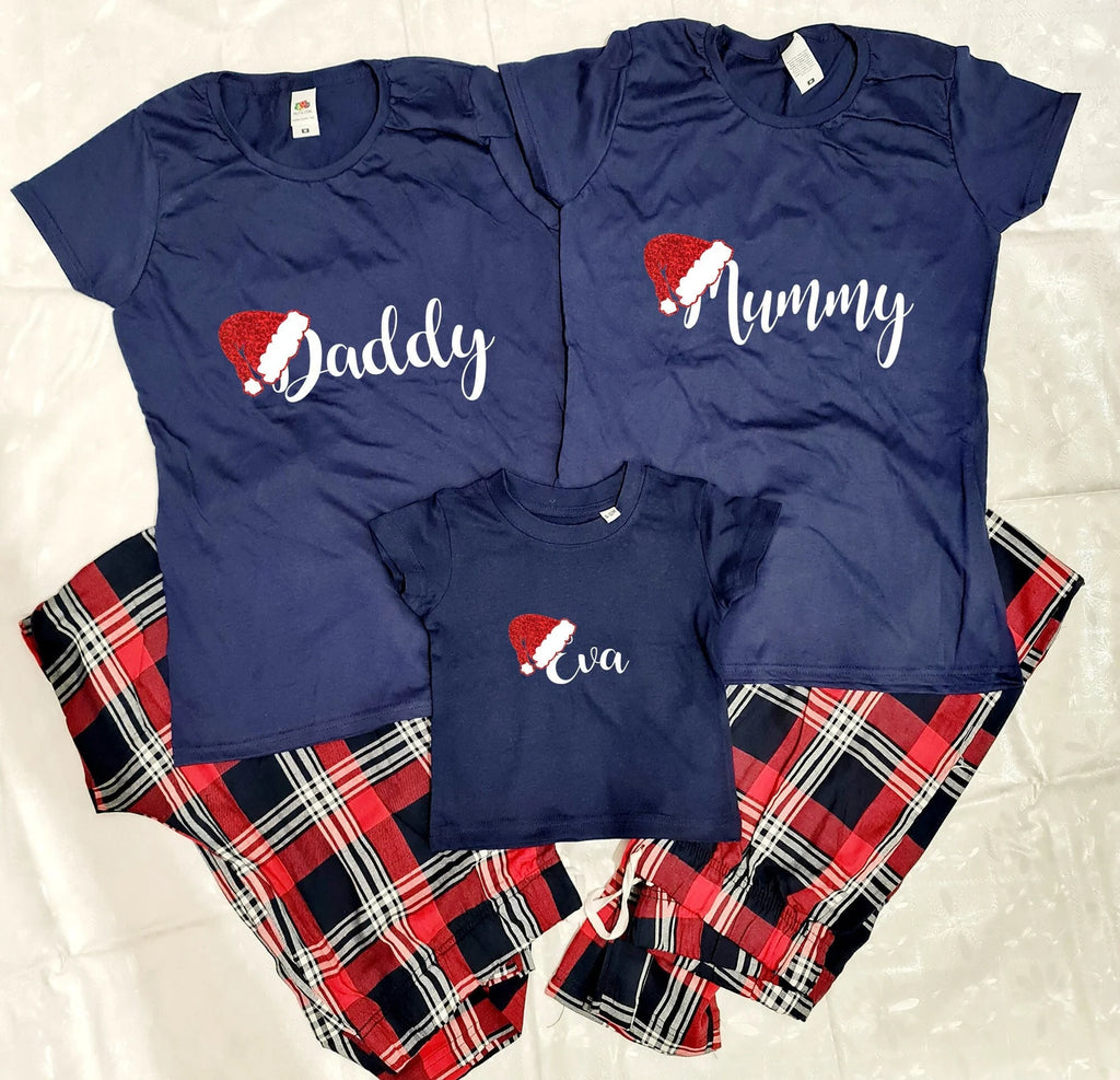 Personalised Santa Hat Christmas Pyjamas set. Set comprises of Navy Blue t-shirt and red tartan pants