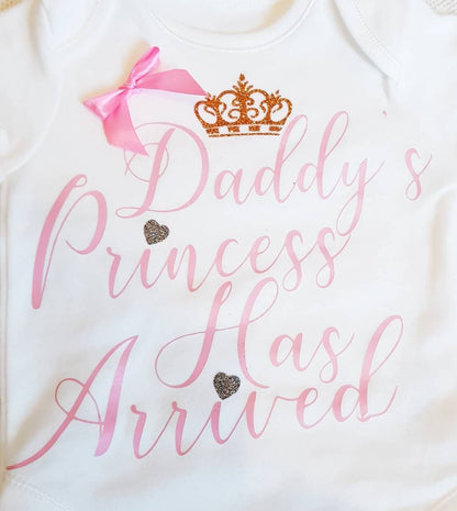 Daddy's Princess Has Arrived baby bodysuit displayed flat showing full front design with bow