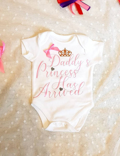 Daddy's Princess Has Arrived white newborn baby bodysuit with pink satin bow detail and vinyl lettering