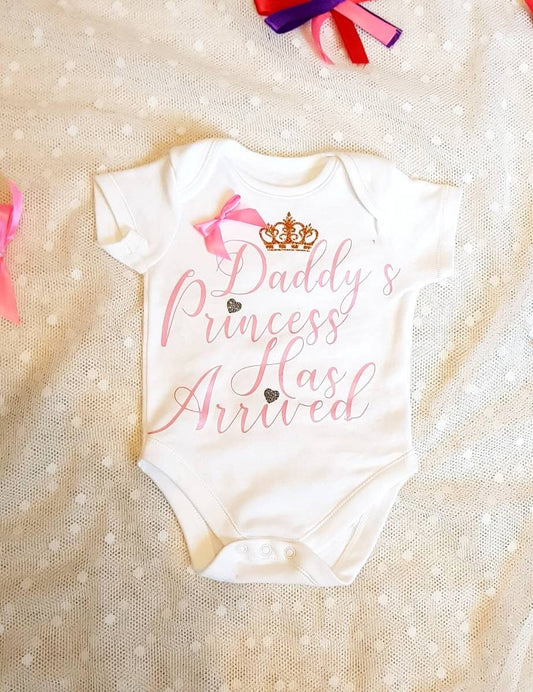 Daddy's Princess Has Arrived white newborn baby bodysuit with pink satin bow detail and vinyl lettering