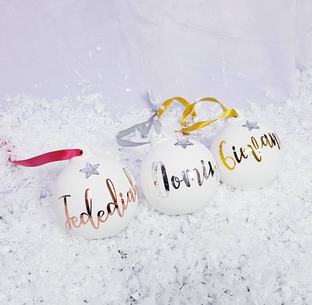 Personalised ceramic Christmas bauble in rose gold with frosted star and custom name