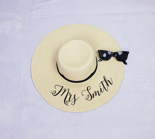 Personalised black floppy beach hat with custom text, perfect for honeymoons and hen parties