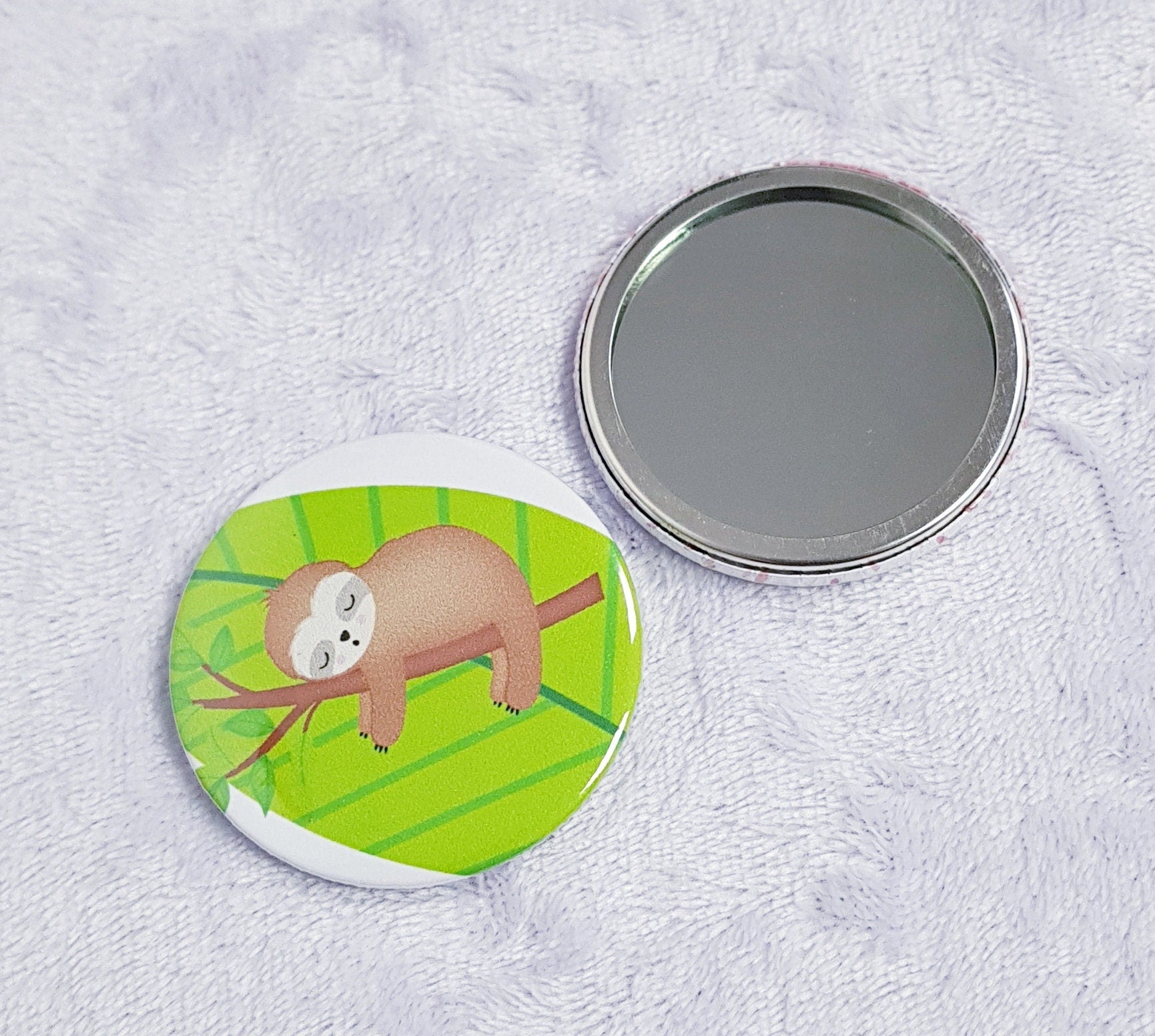Cute sloth compact pocket mirror showing adorable sloth design on front, 5.8cm diameter