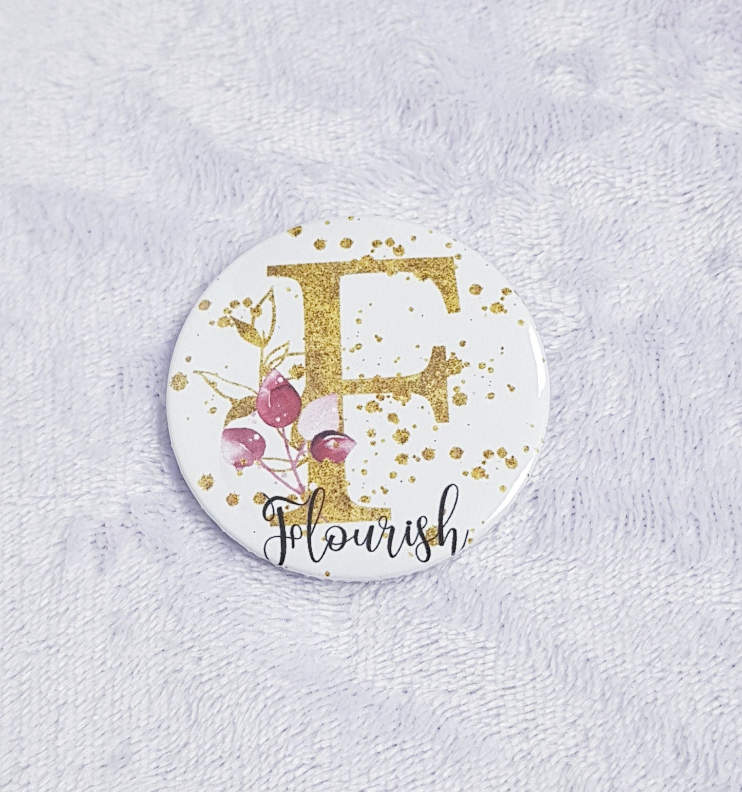 Gold floral initial pocket mirror showing front design and back mirror surface