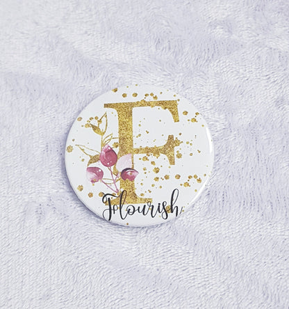 Gold floral initial pocket mirror showing front design and back mirror surface