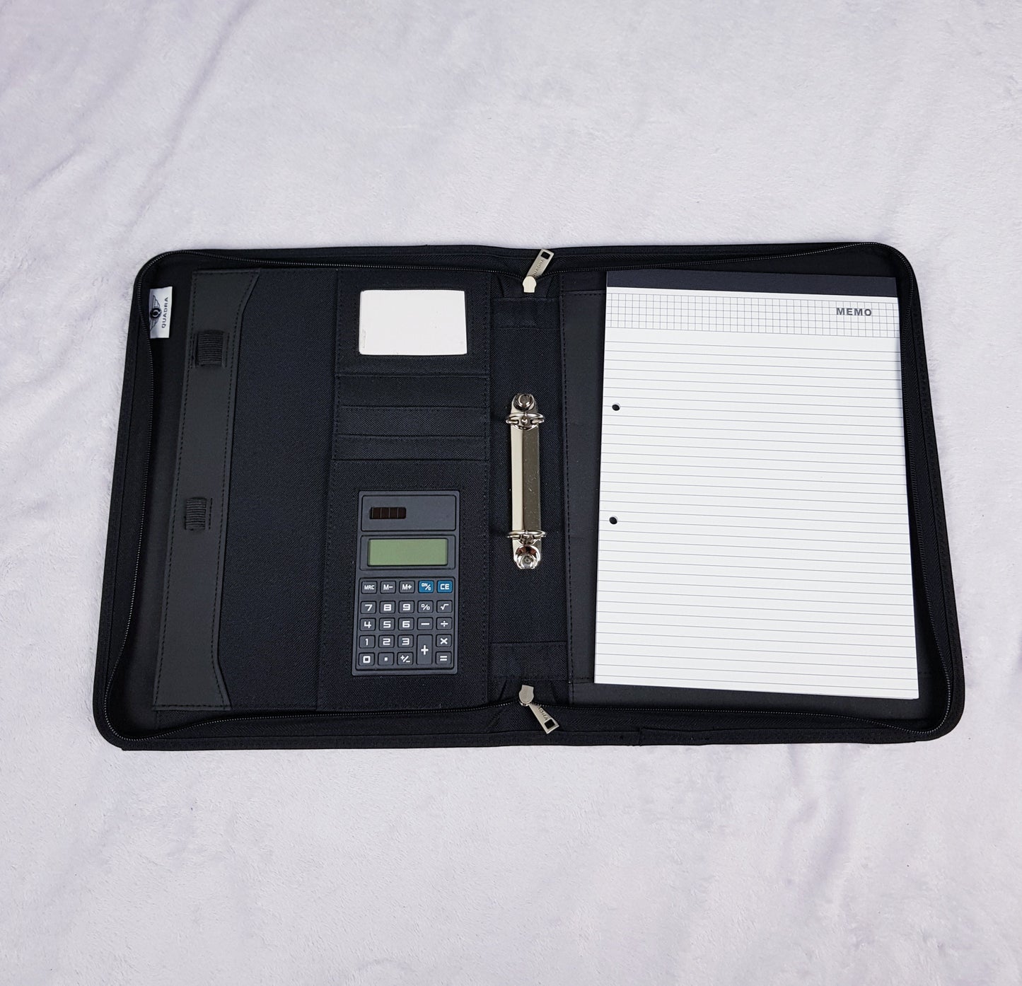 Interior of personalised portfolio organiser showing card slots, ring binder, calculator and writing pad