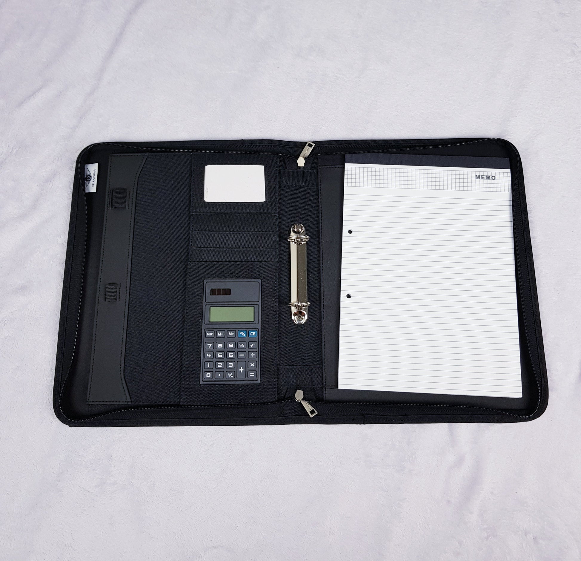Interior of personalised portfolio organiser showing card slots, ring binder, calculator and writing pad