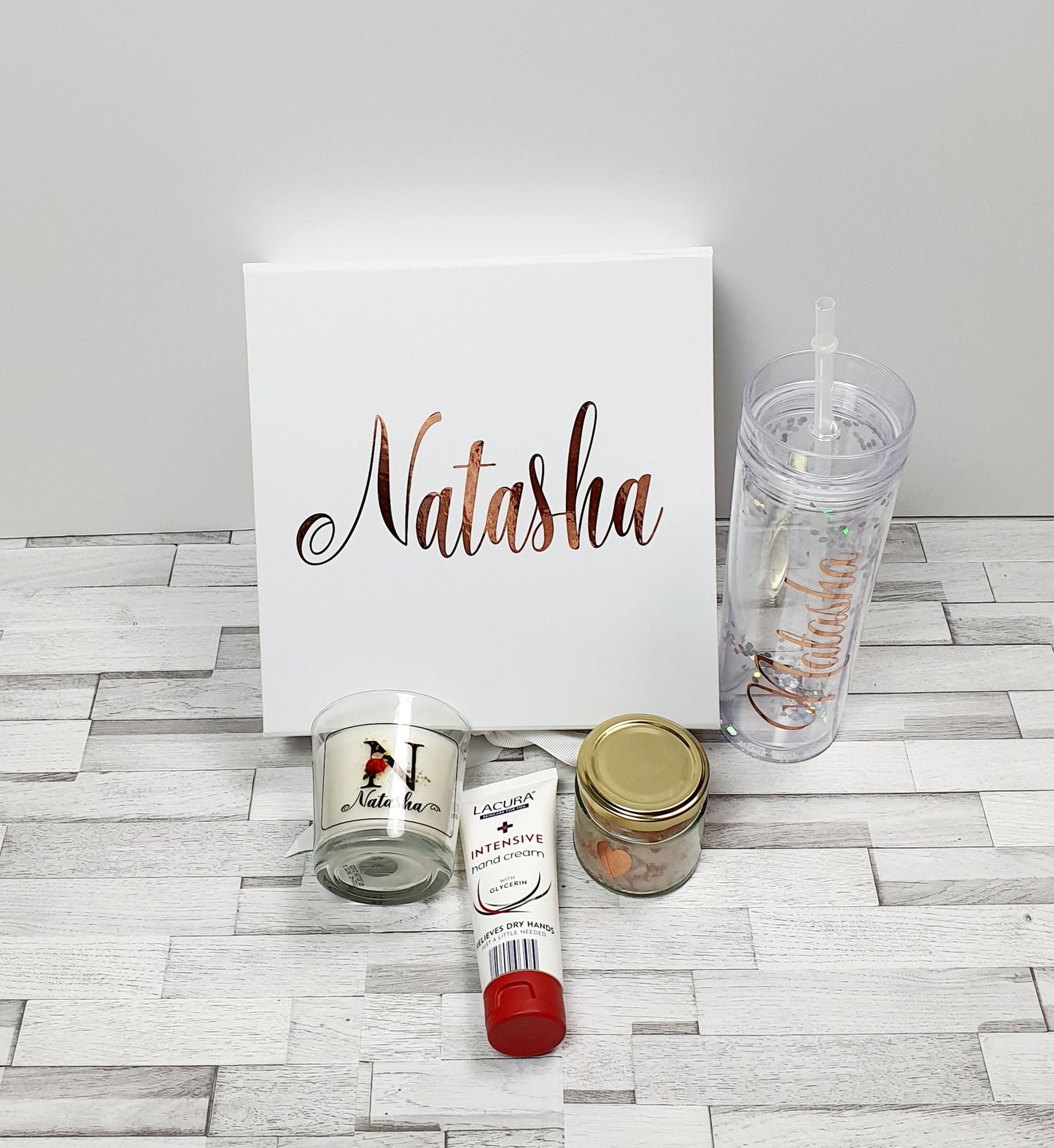 Contents of luxury bridesmaid gift box showing personalised glitter straw cup and candle