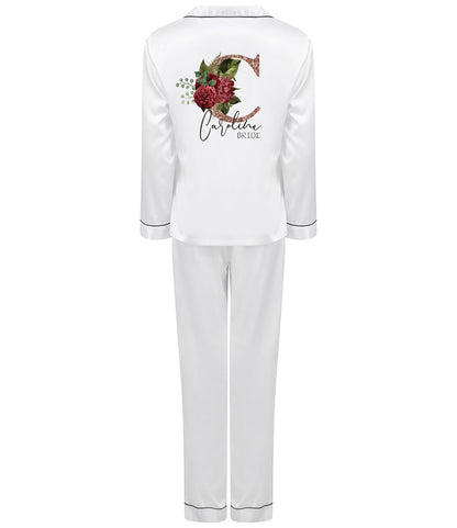 Personalised white satin bridal pyjama set with rose gold floral initial and name, folded and styled for display