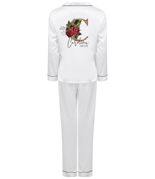 Personalised white satin bridal pyjama set with rose gold floral initial and name, folded and styled for display