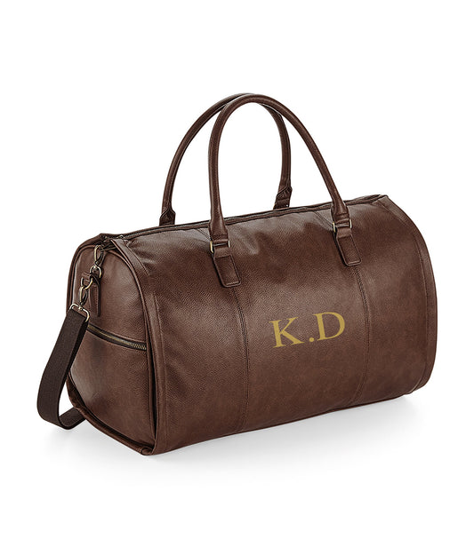 Personalised tan leather-look holdall showing NuHide PU leather material and carry handles