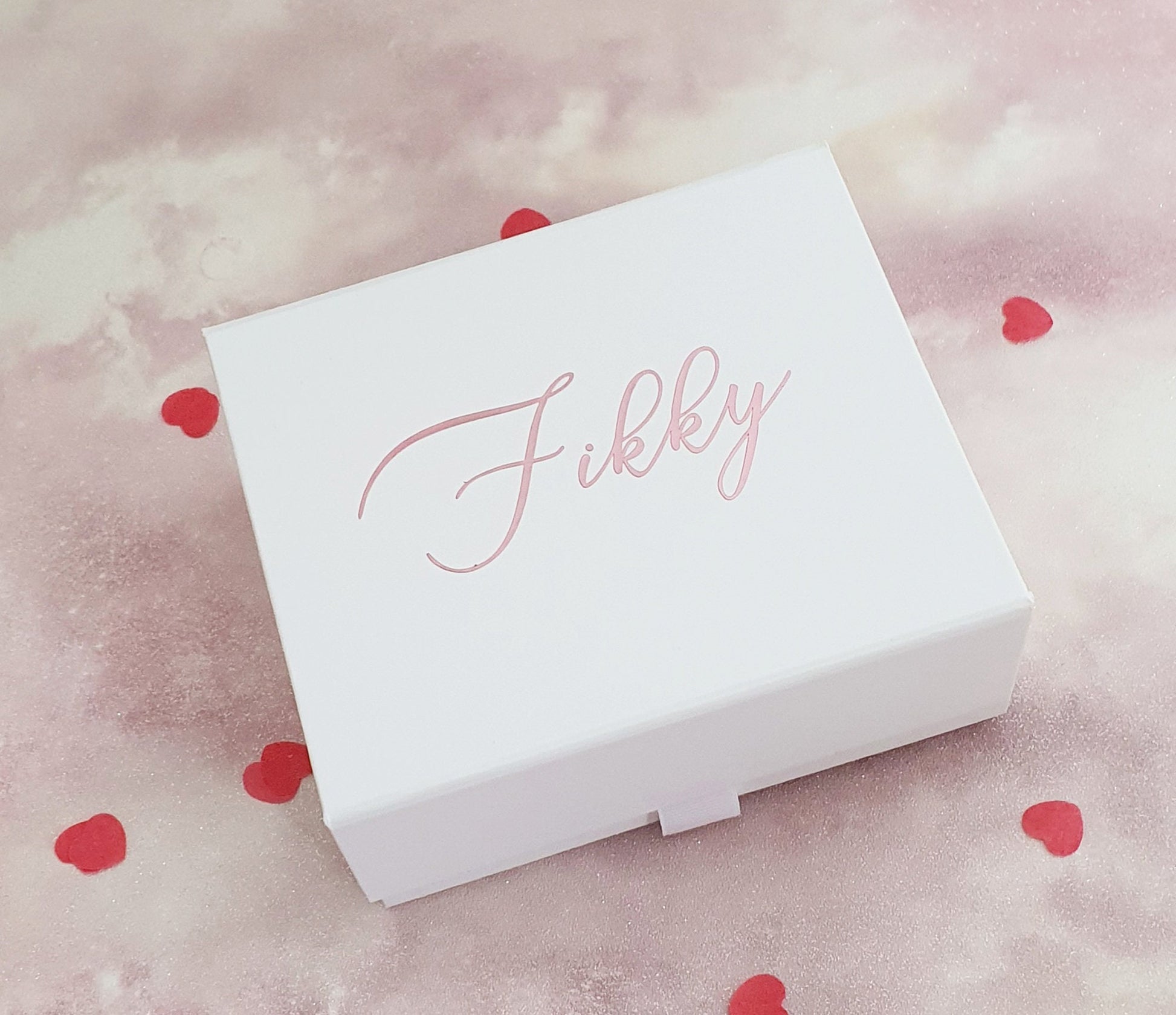 Contents of rose gold luxury pamper gift box showing vegan bath products and personalised card
