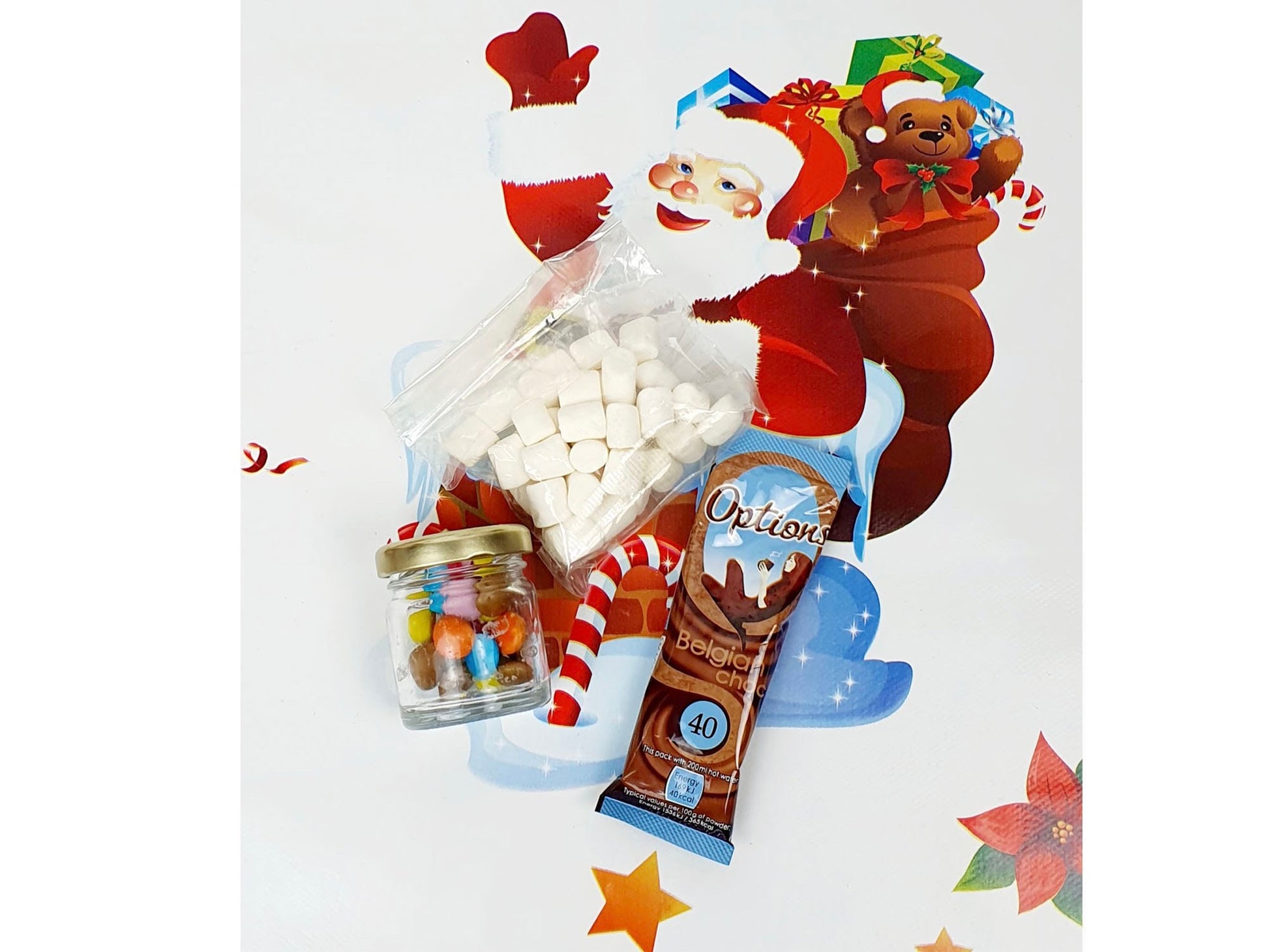 Contents of penguin Christmas stocking filler jar showing sweeties and hot chocolate sachets
