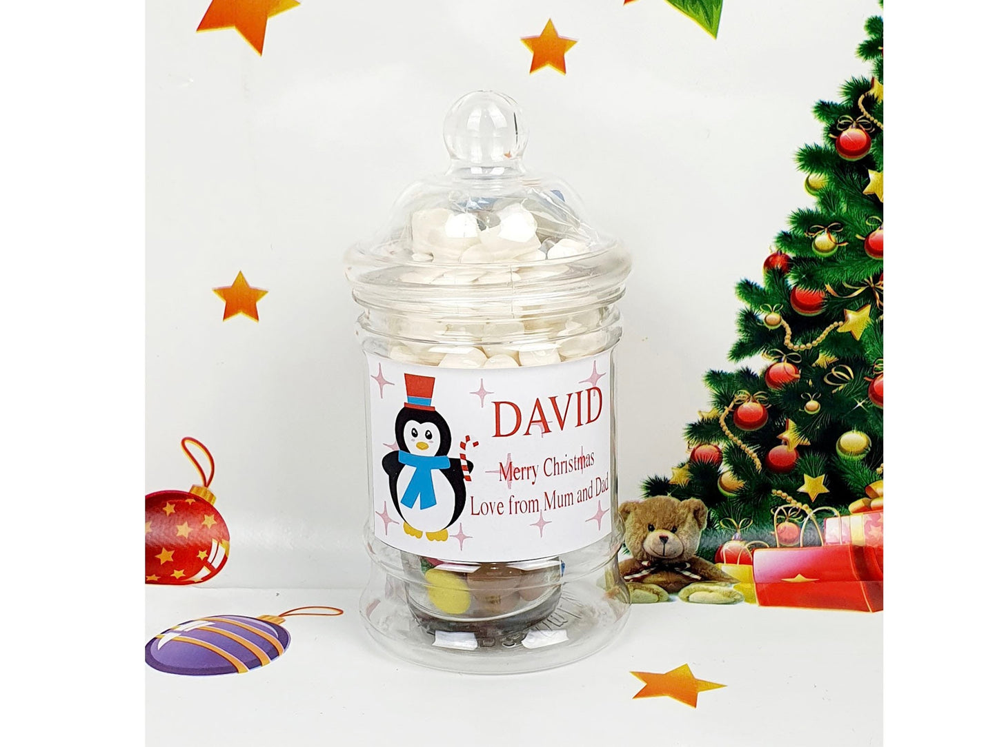 Personalised penguin Christmas treat jar filled with marshmallows, chocolate and candy cane