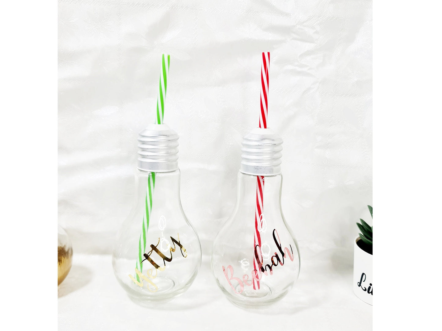 Personalised bauble-shaped gin glass with custom name and striped straw, festive novelty gift