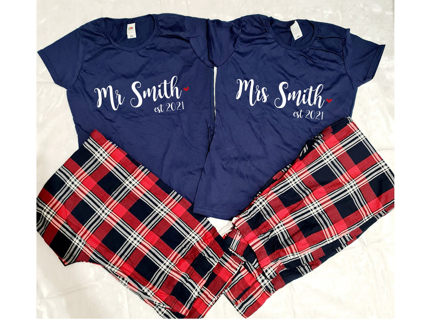 Personalised Mr and Mrs matching couple's tartan pyjama sets displayed together with custom names
