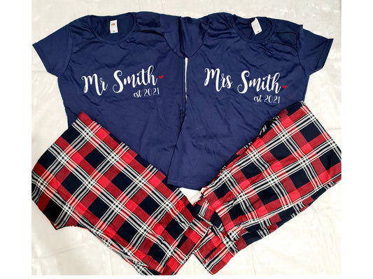 Personalised Mr and Mrs matching couple's tartan pyjama sets displayed together with custom names