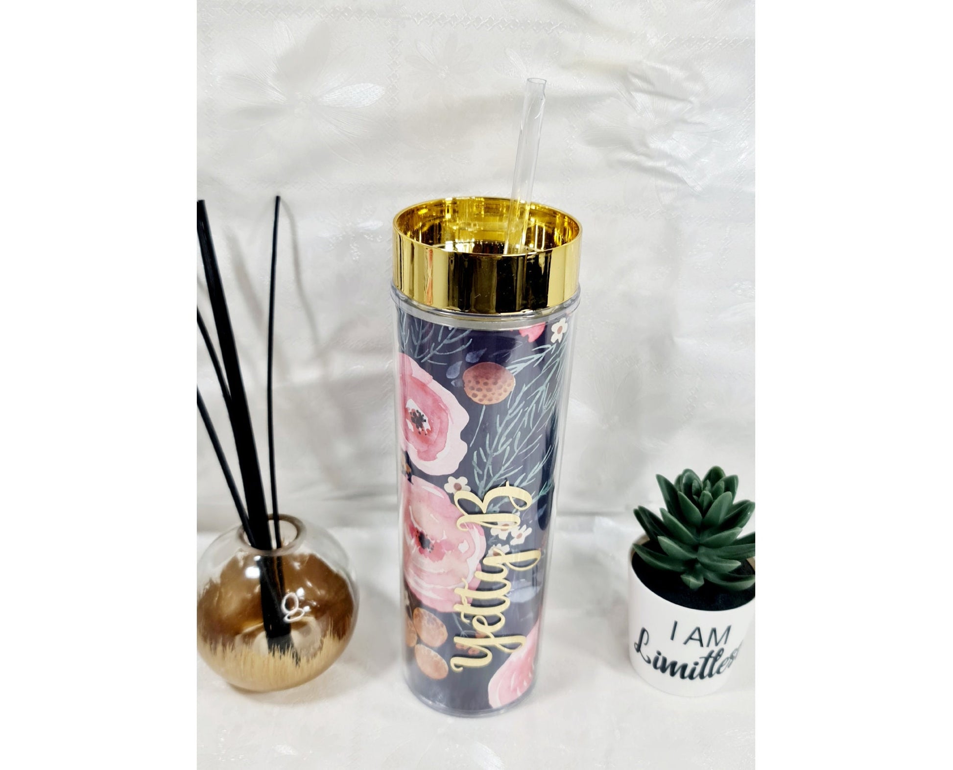 Personalised tumbler cups with straws displayed for bridesmaid gifts