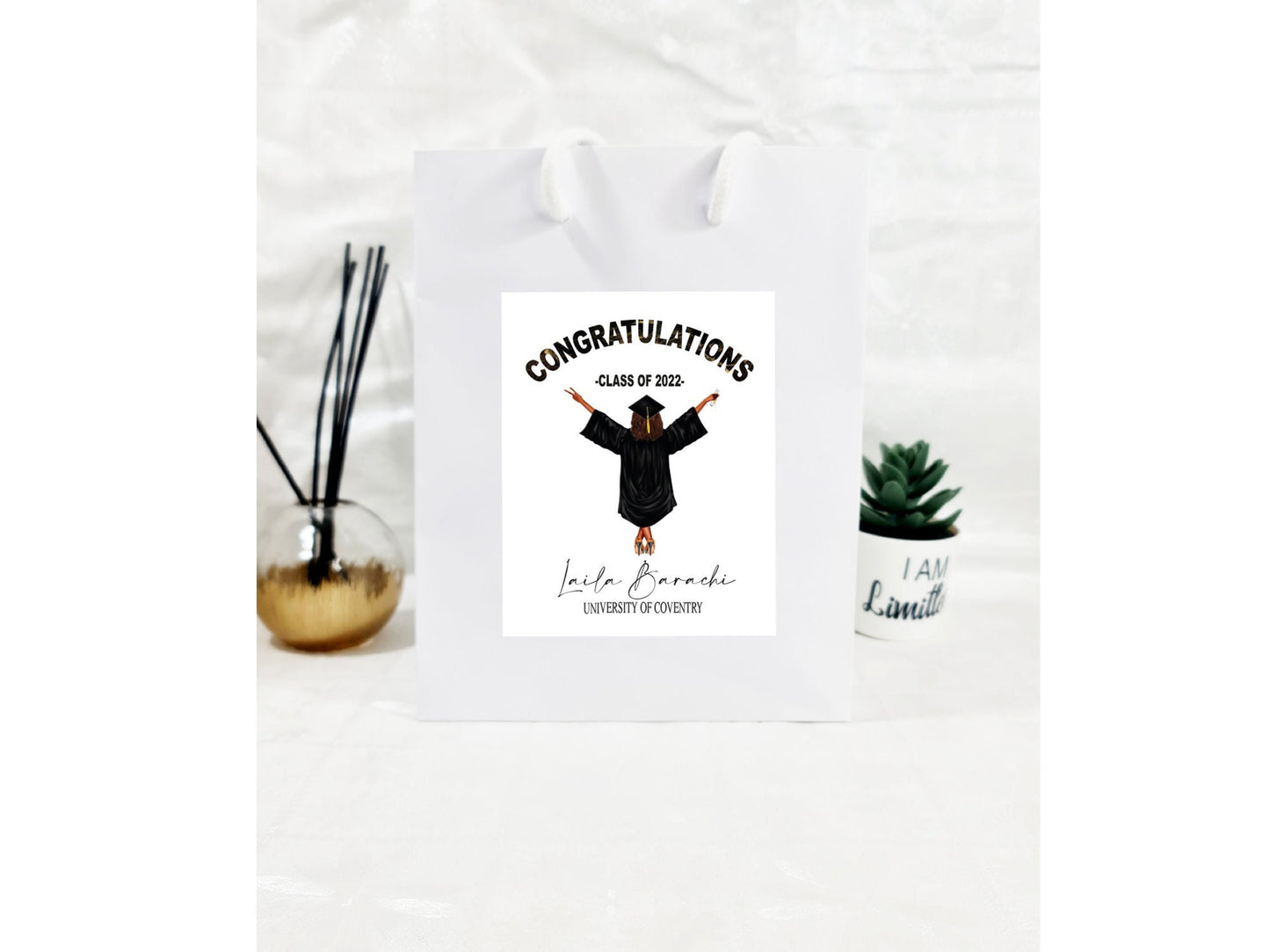 Personalised graduation gift bag with custom illustration of graduate showing name and school