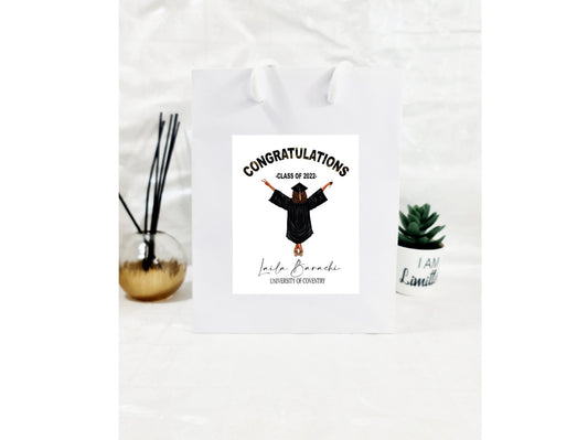 Personalised graduation gift bag with custom illustration of graduate showing name and school