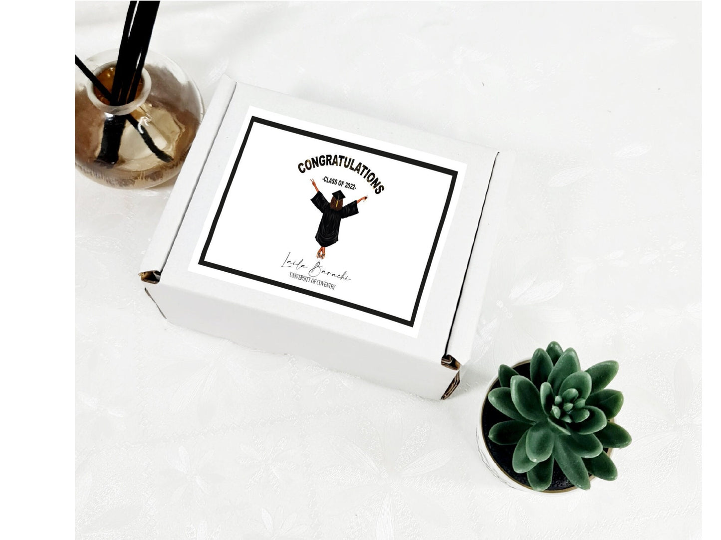 Personalised graduation gift box with custom illustration of graduate and treats inside